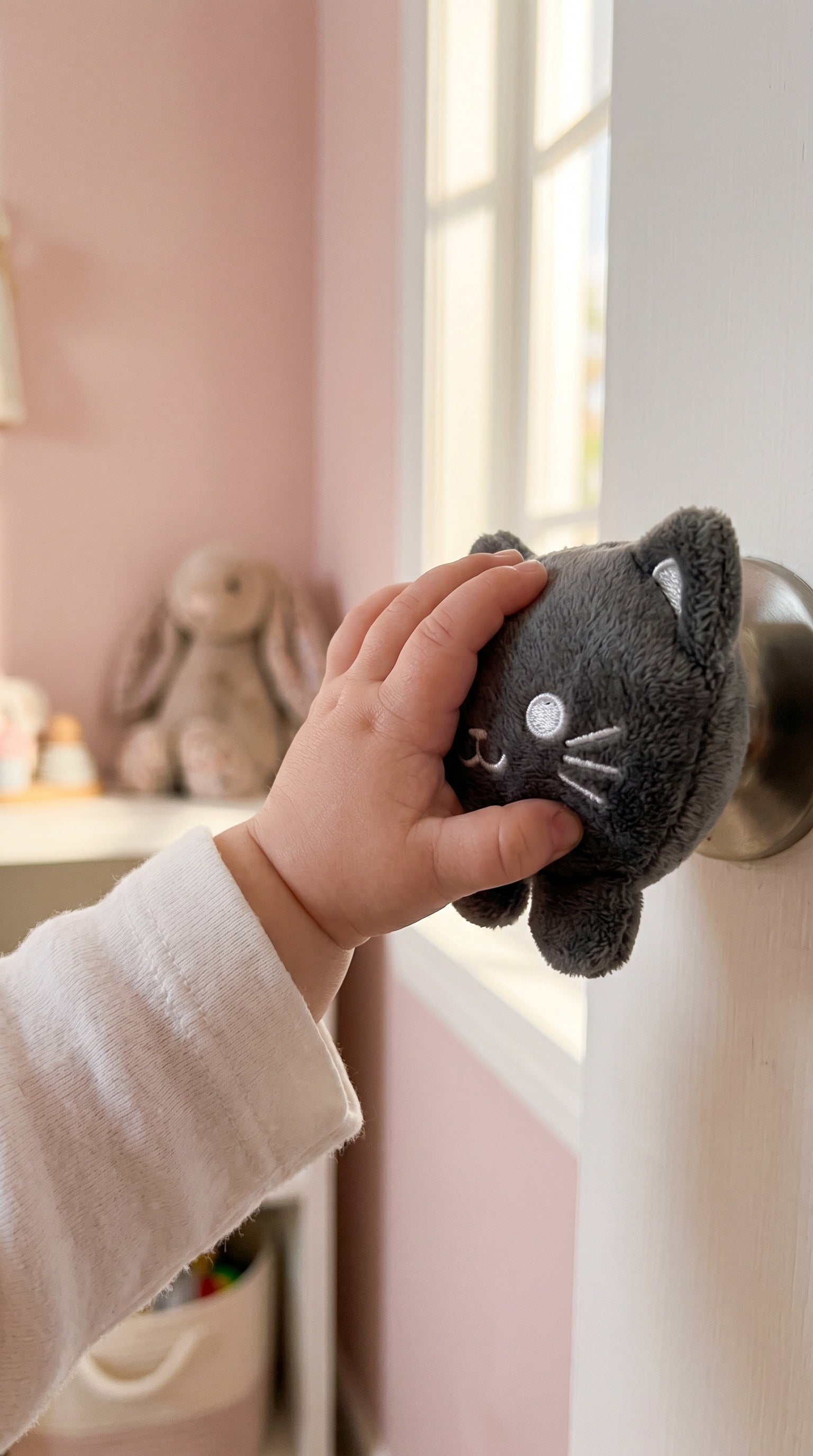 Baby reaching for a Cute Futures doorknob cover